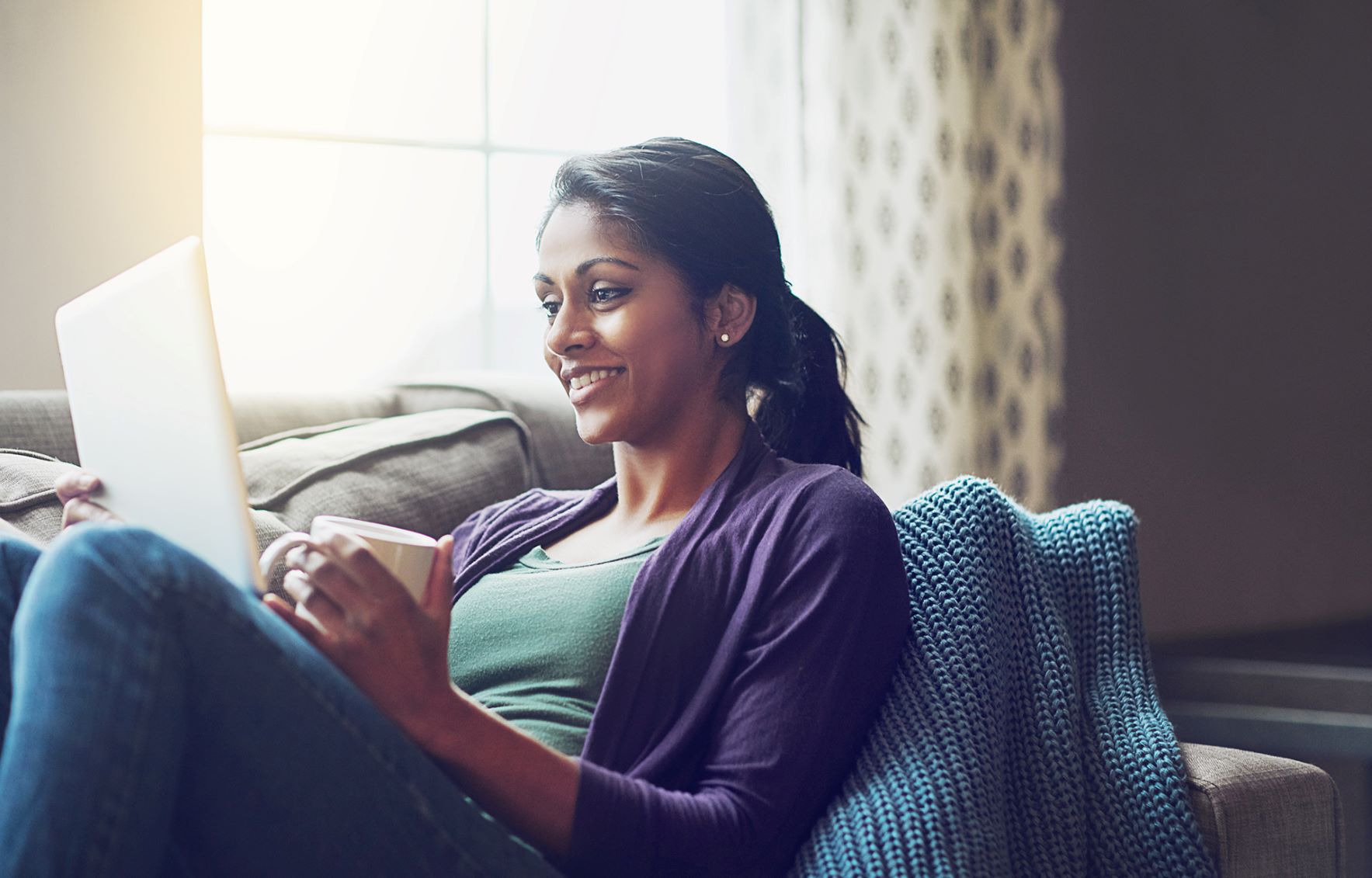 Woman sitting on couch reading