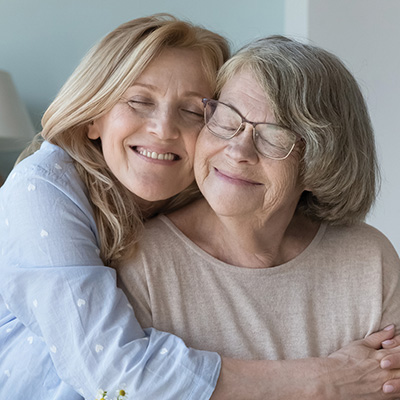 Two people hugging and smiling