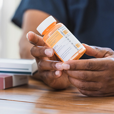 Person holding a medication bottle