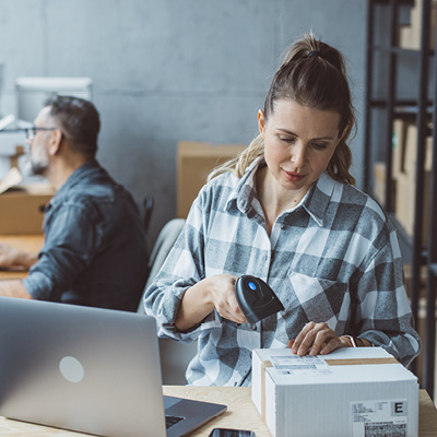 woman scanning a box to ship