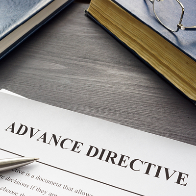 Advance Directive paper on desk with pen and books