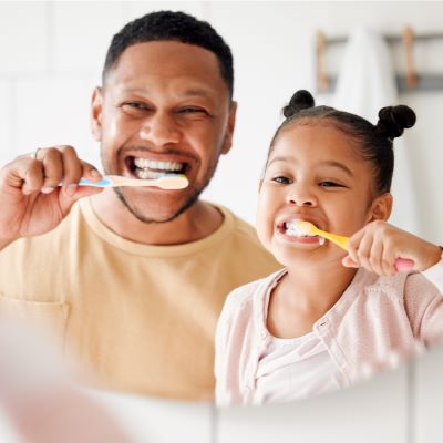 Two people brushing their teeth