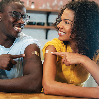 two people with bandiads from a shot