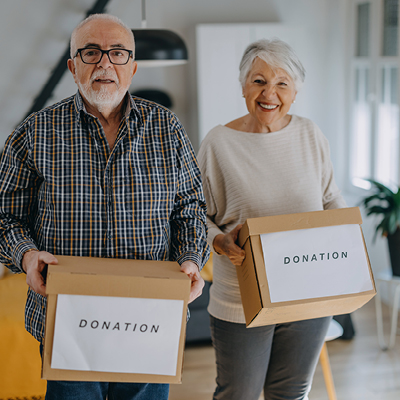 Older couple holding donation boxes