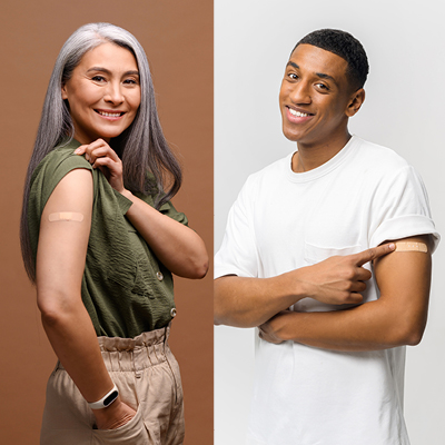 Two people posing with band aids on their arm