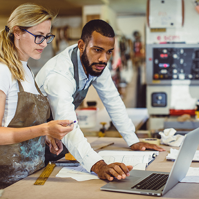 two people looking at a laptop
