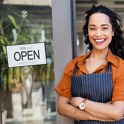 Woman in front of an open sign on a door