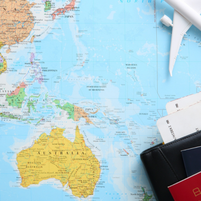 World map with passport on the side and plane above