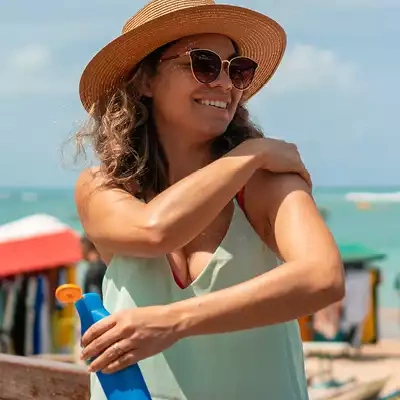 Woman putting on sunscreen