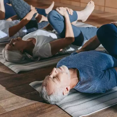 People laying on yoga mats